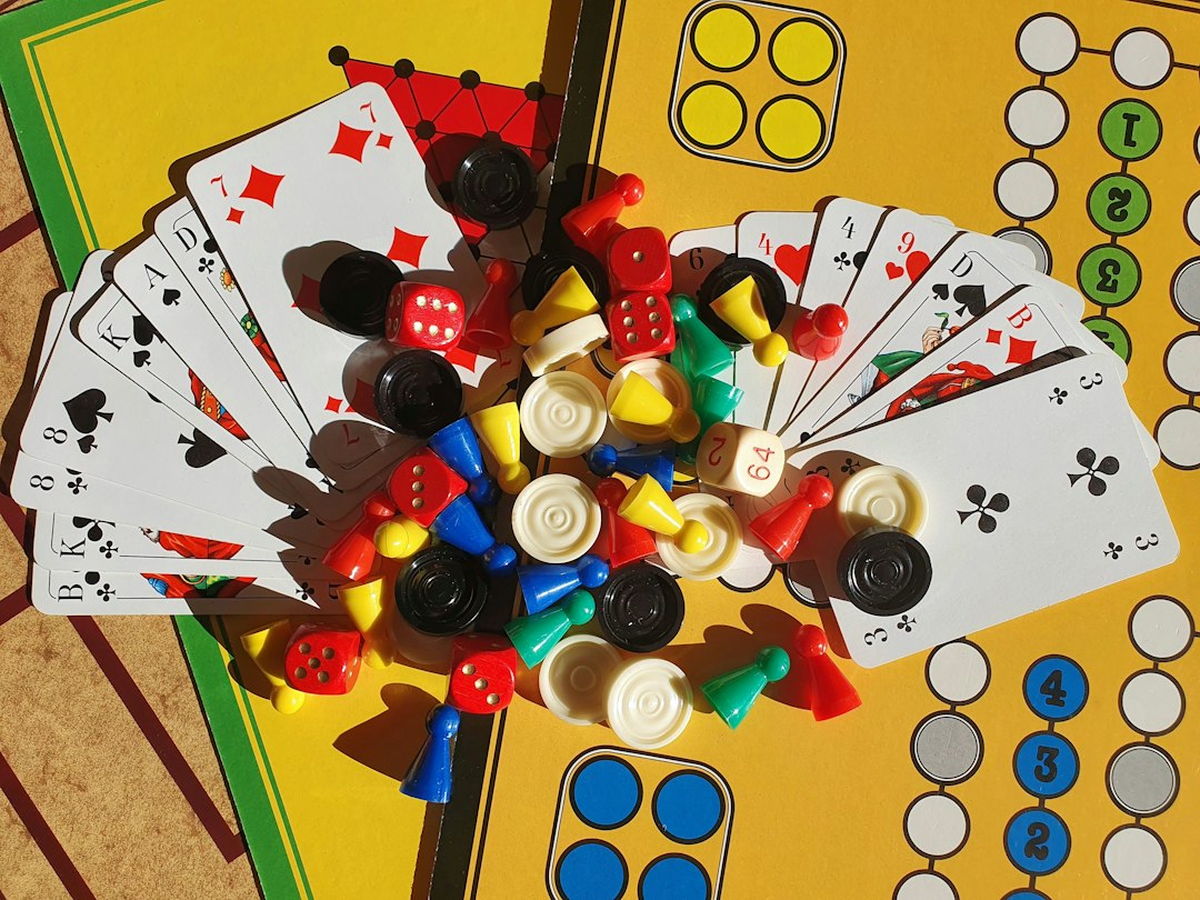 Assorted board games, playing pieces, dice and cards arranged on a table