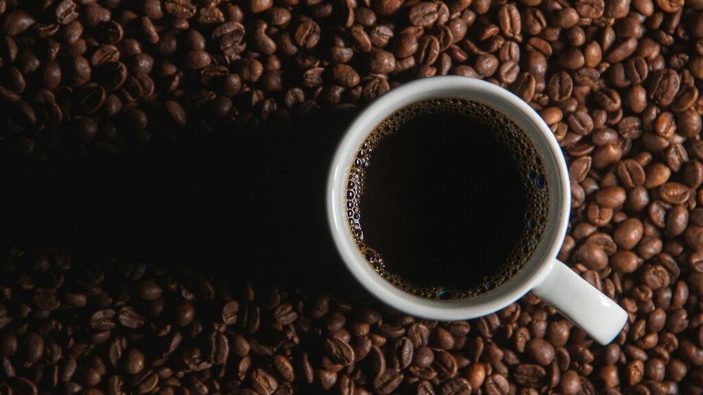 Coffee cup and coffee beans, an illustrative scene for coffee and tea choices