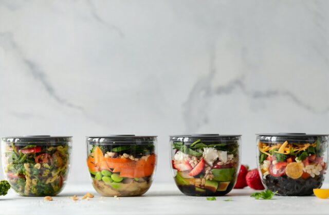 Food storage containers holding vegetables, illustrative kitchen photograph