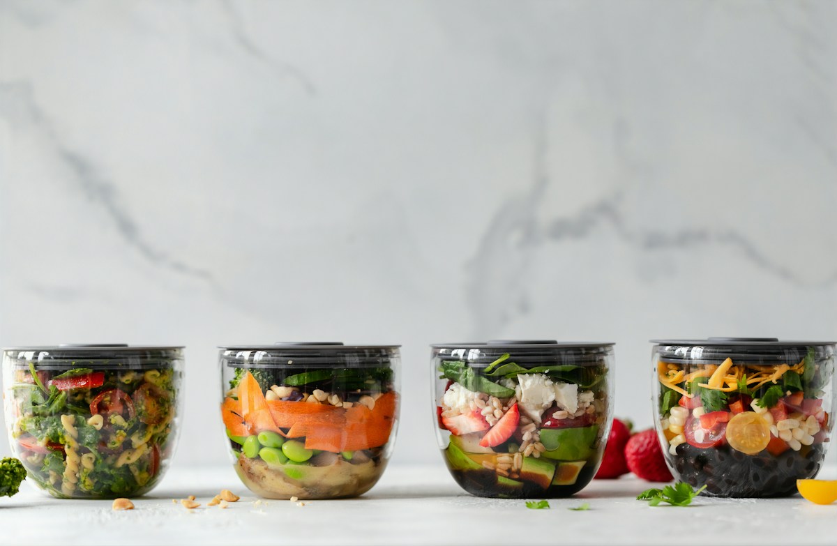 Food storage containers holding vegetables, illustrative kitchen photograph