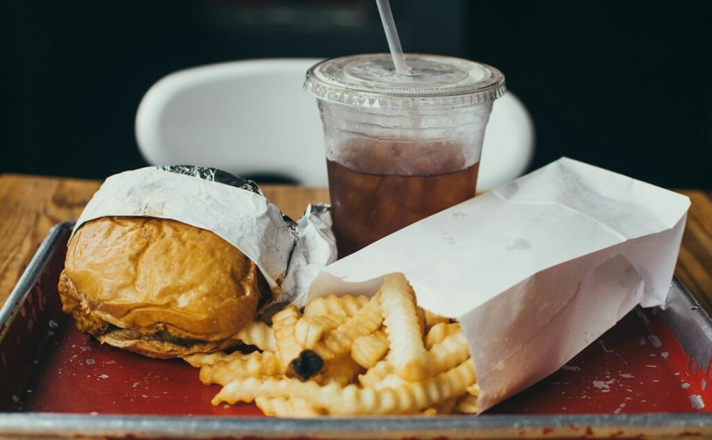Illustrative cheeseburger meal, not an official Sonic product photo; sides and drink are not included in the burger offer