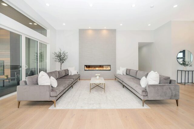 A living room seating area arranged around a rug