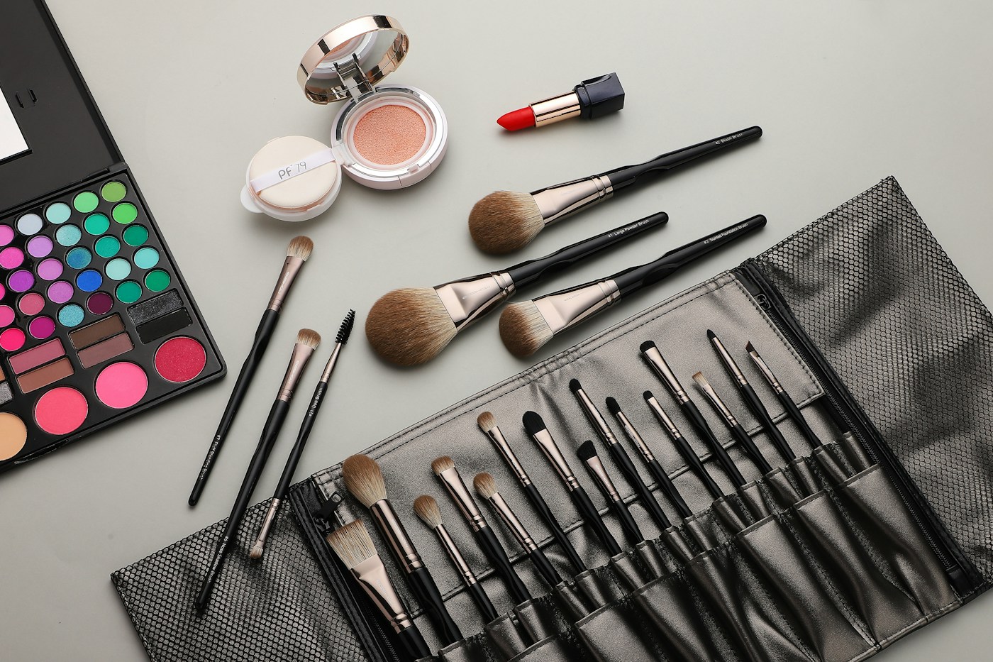 Makeup brushes arranged together, illustrating brush shapes rather than either example kit