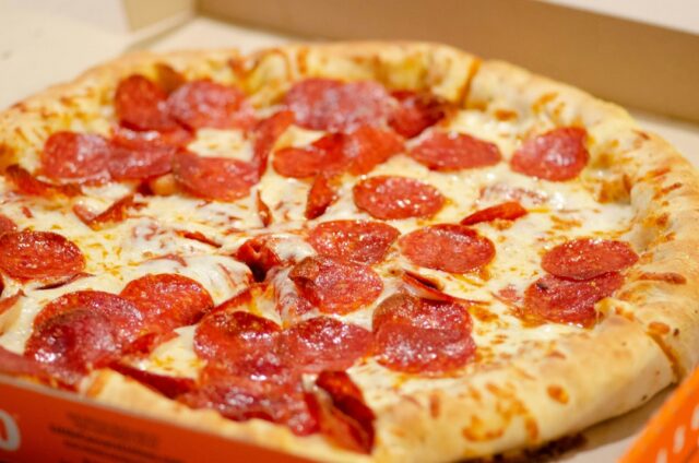 Pepperoni pizza photographed on a table; illustrative image, not a Domino's menu item