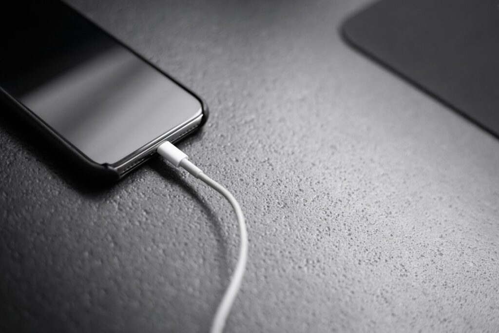 Phone connected to a portable charger; illustrative stock photograph