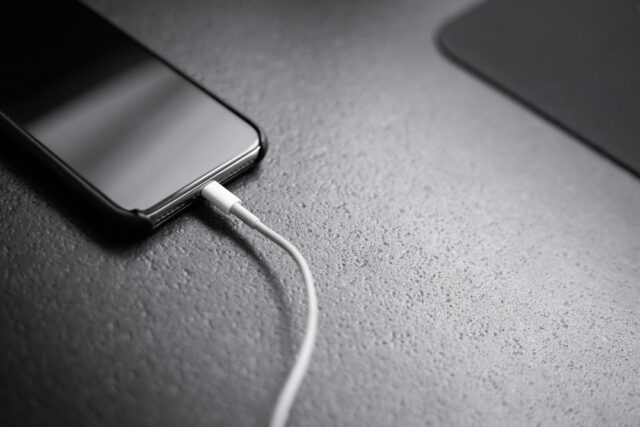 Phone connected to a portable charger; illustrative stock photograph