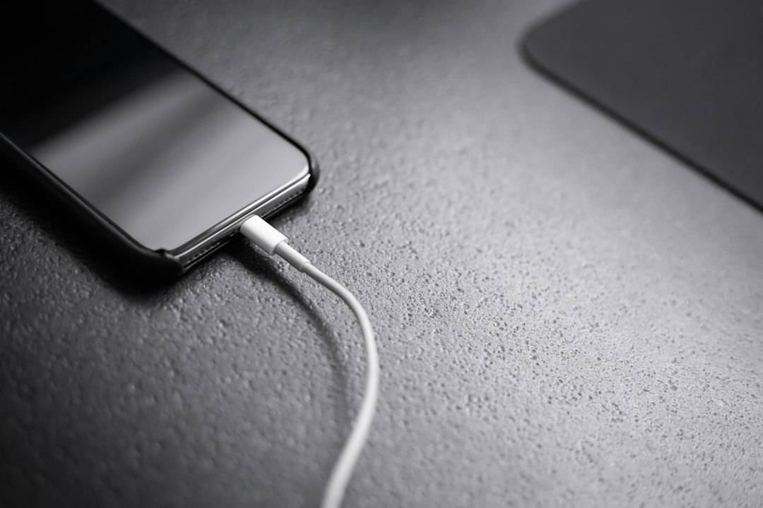 Phone connected to a portable charger in an illustrative stock photograph