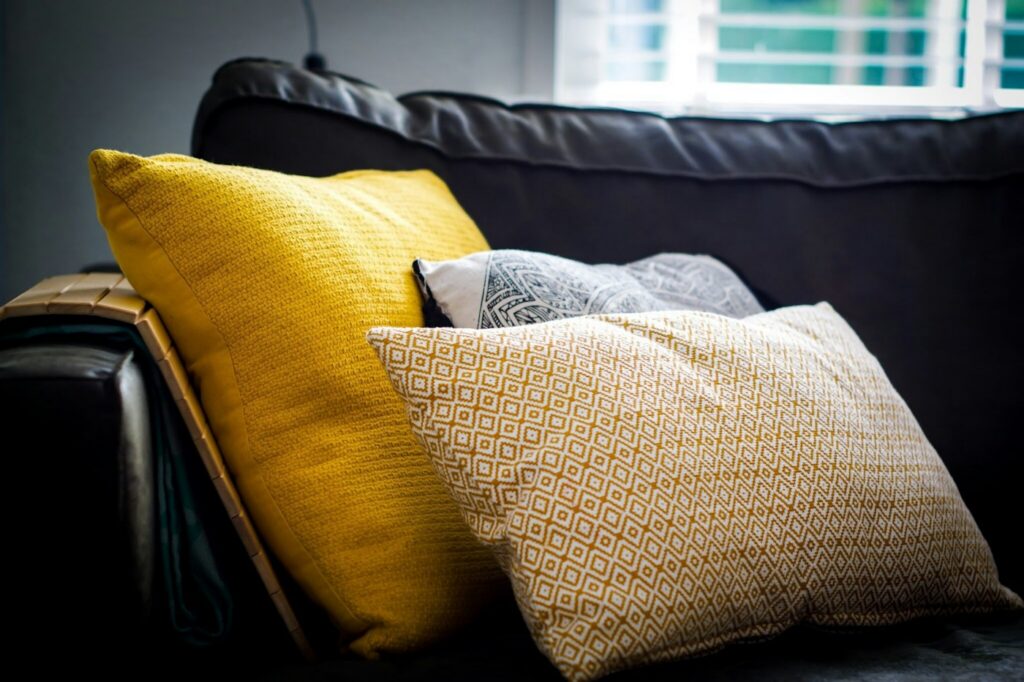 Three throw pillows arranged on a sofa